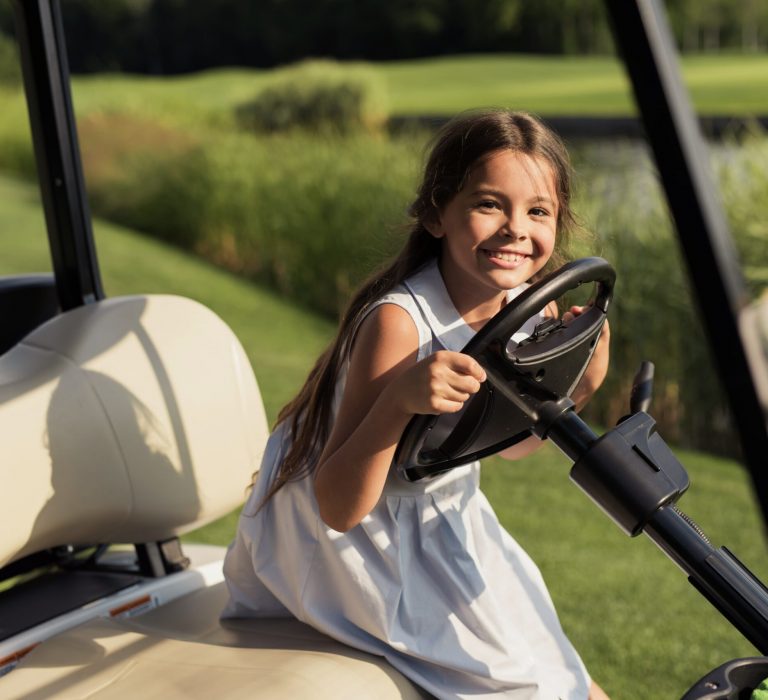 kids-hobby-child-at-the-wheel-of-luxury-golf-car-min